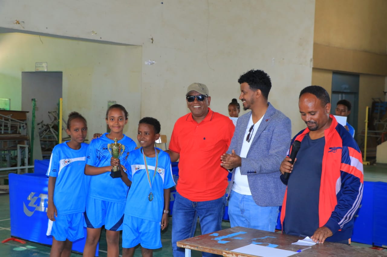 Young players standing alongside program representatives