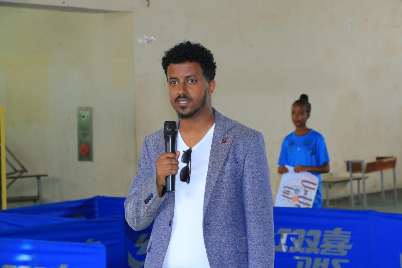 A speaker addressing the gathering with a microphone