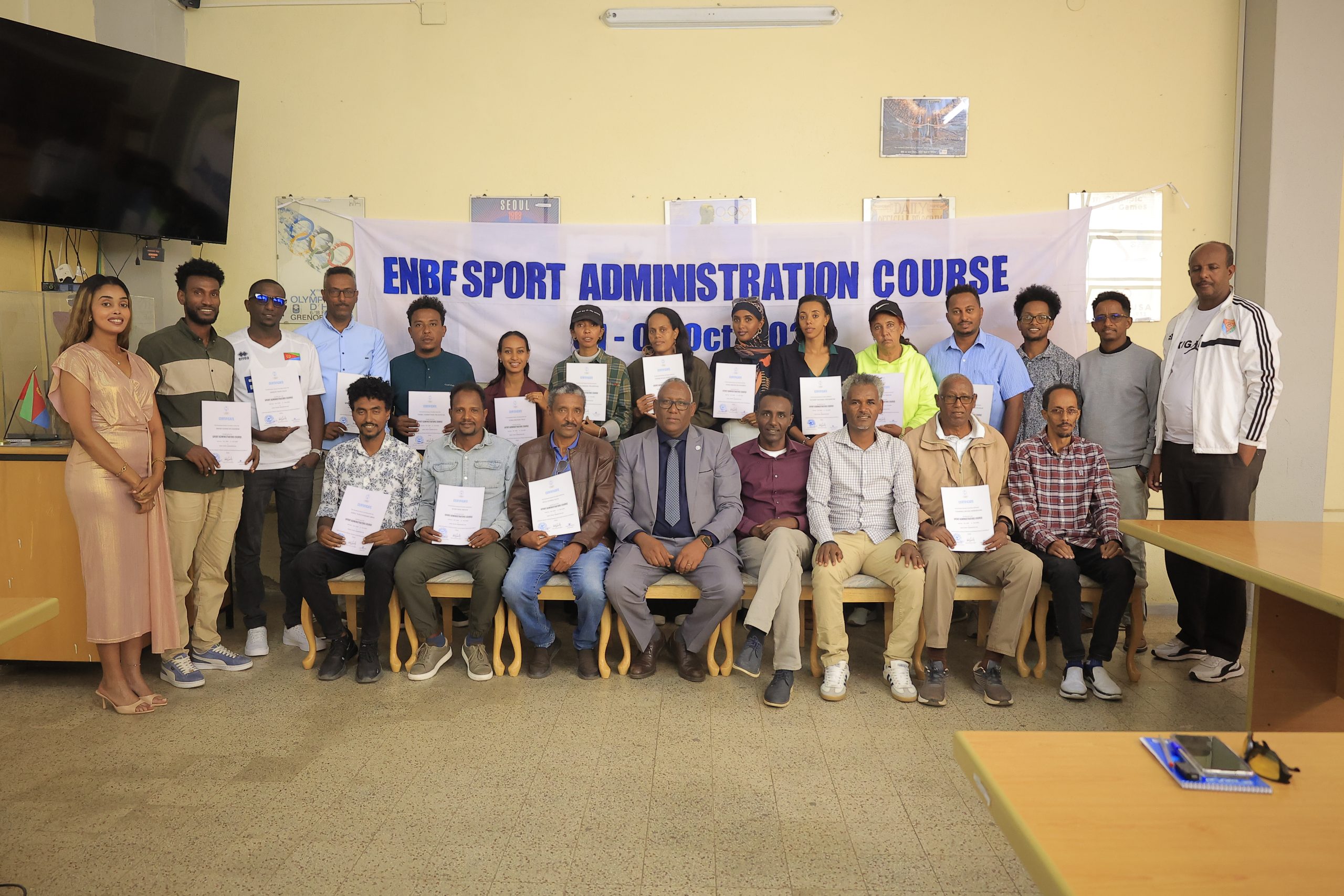 ENBF sports administration course participants and officials with completion certificates.