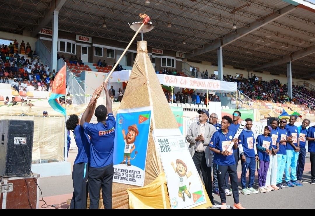 Lighting the ceremonial torch at Asmara Stadium during the Dakar 2026 Flame Tour.